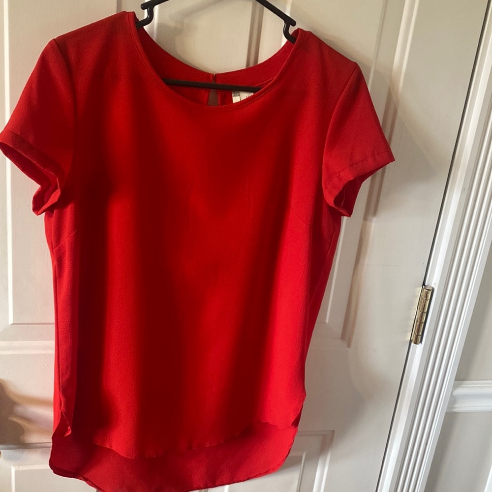 red loose fit, cap sleeve, back button accent, professional blouse